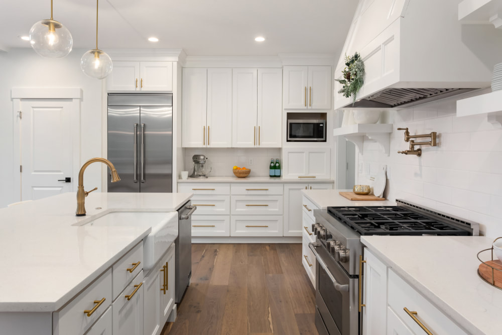 White cabinets and quartz countertops with eased edge, apron sink, fabricator
